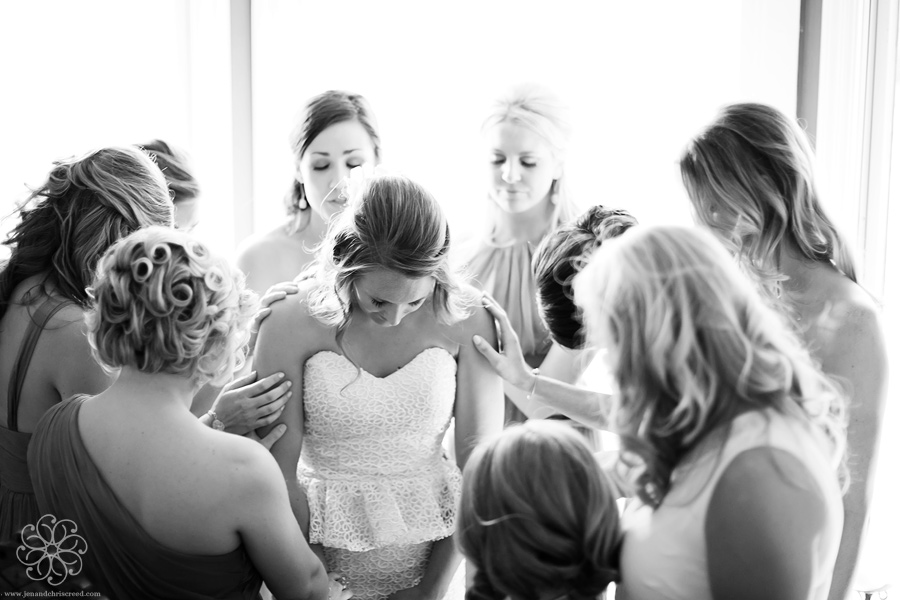 bride and bridesmaids praying