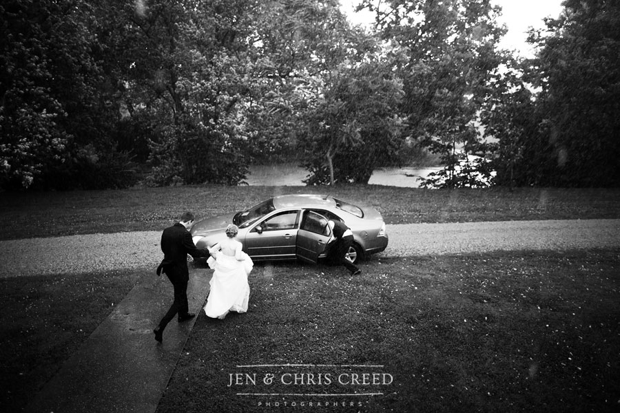 bride and groom getting in car