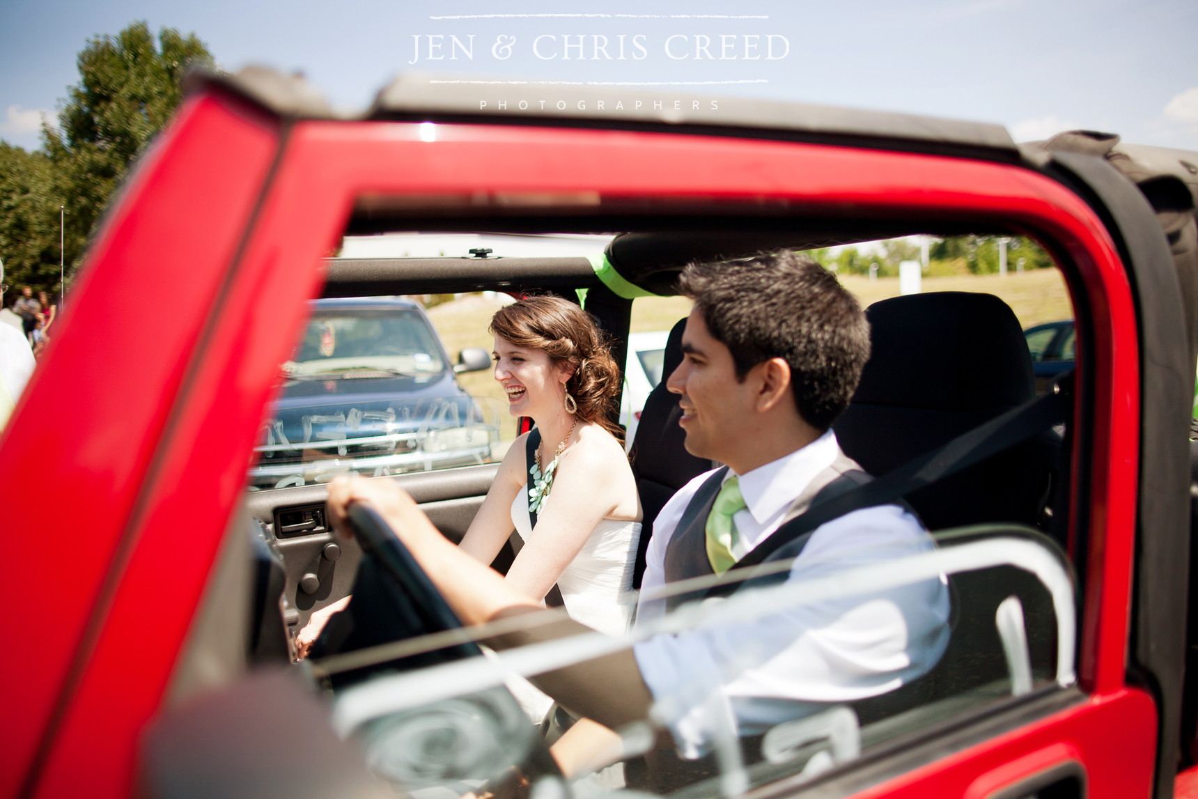 bride and groom leaving in Jeep