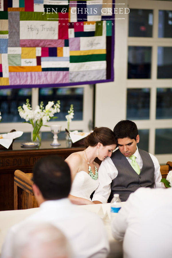 bride and groom praying during reception