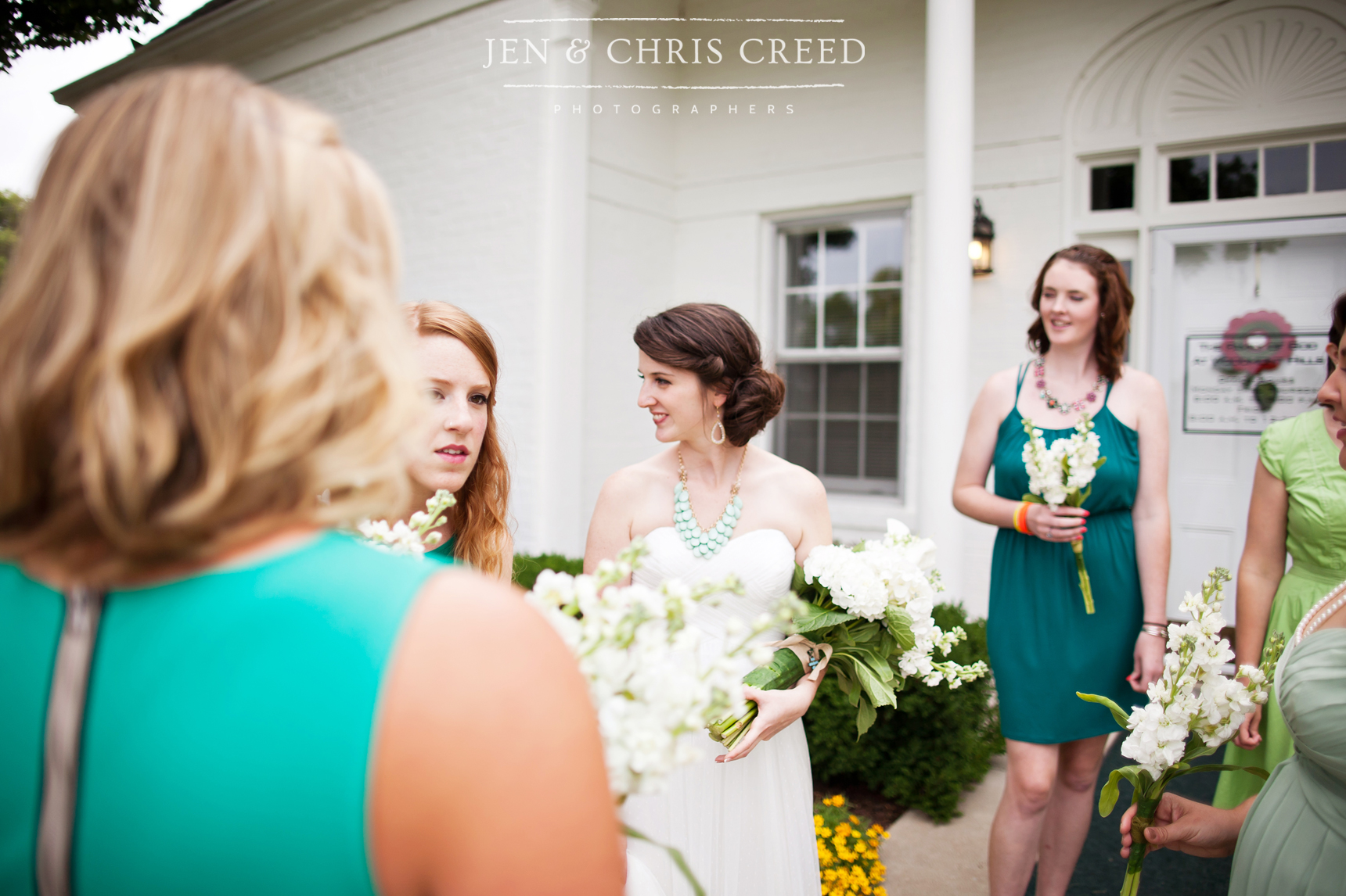 bride with bridesmaids in green