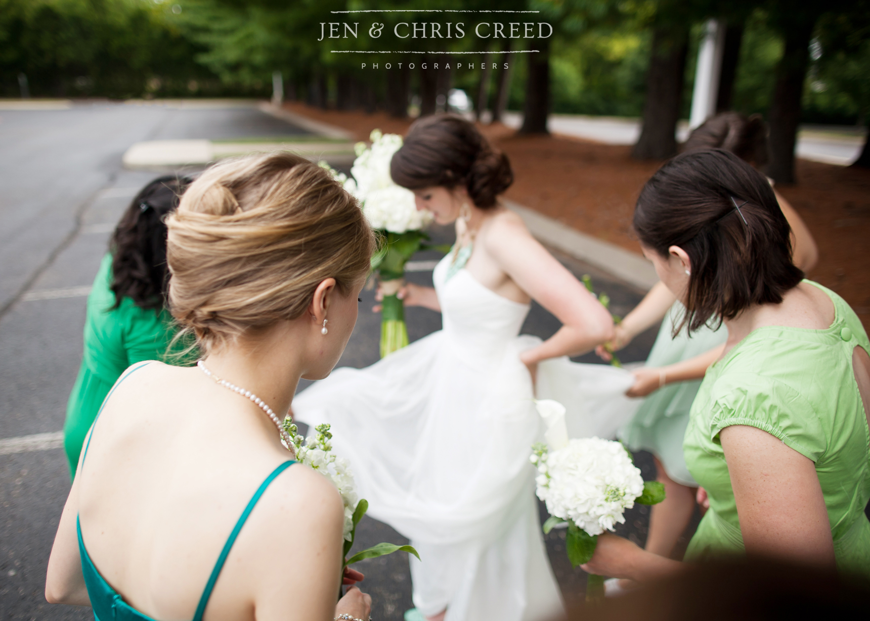 bridesmaids helping bride with dress