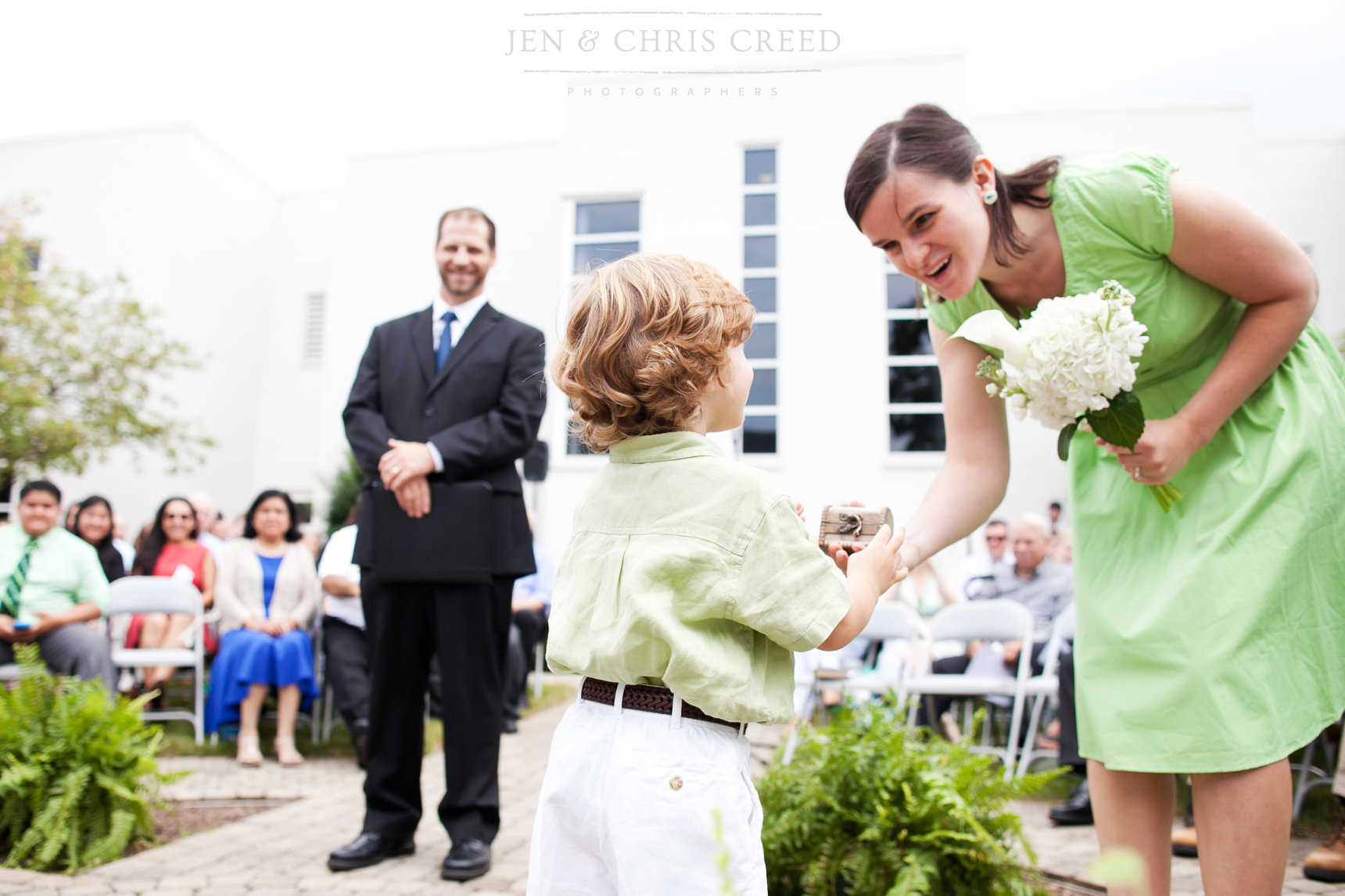 ring bearer handing ring to maid of honor