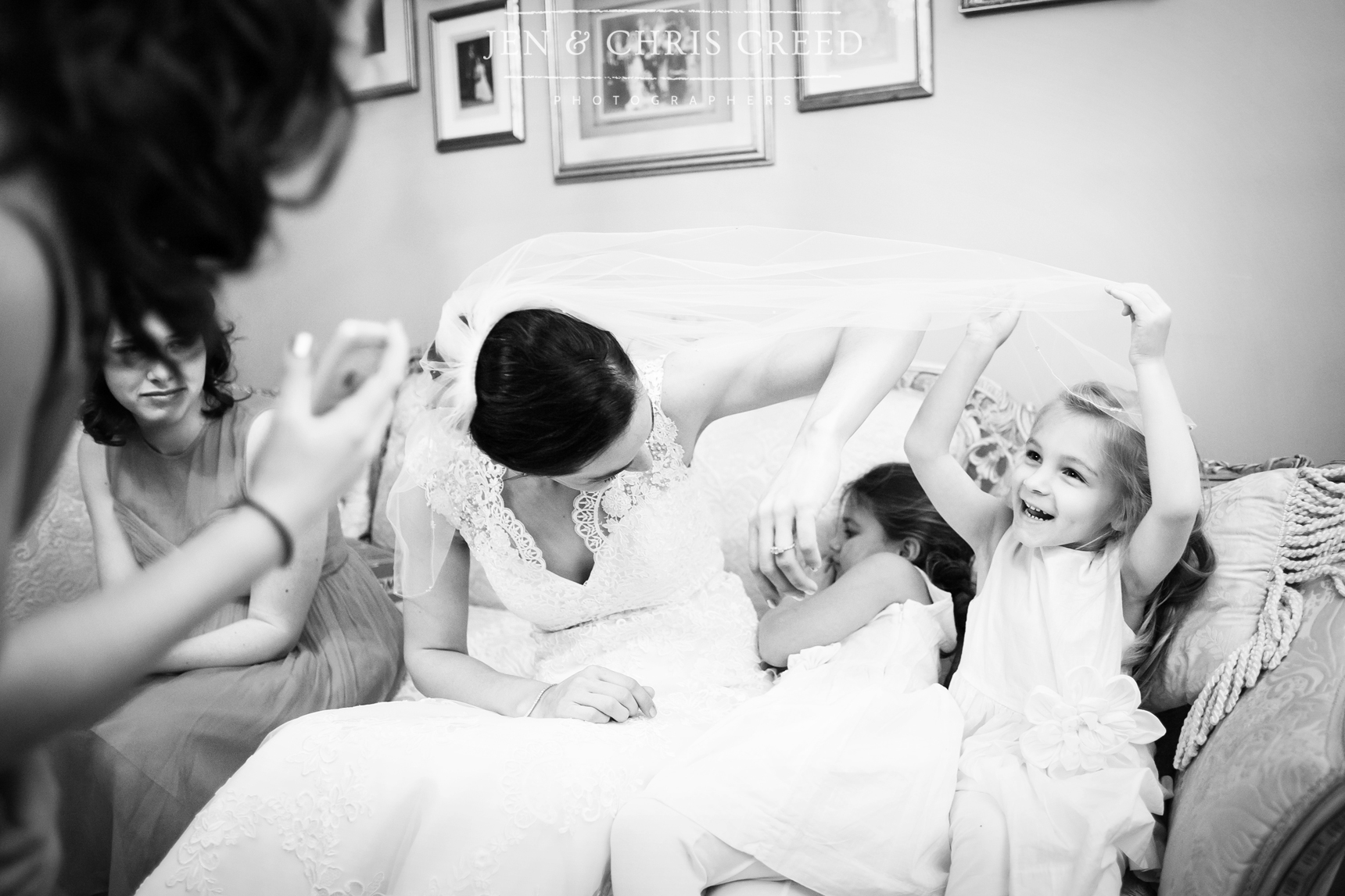 bride laughing with flower girls