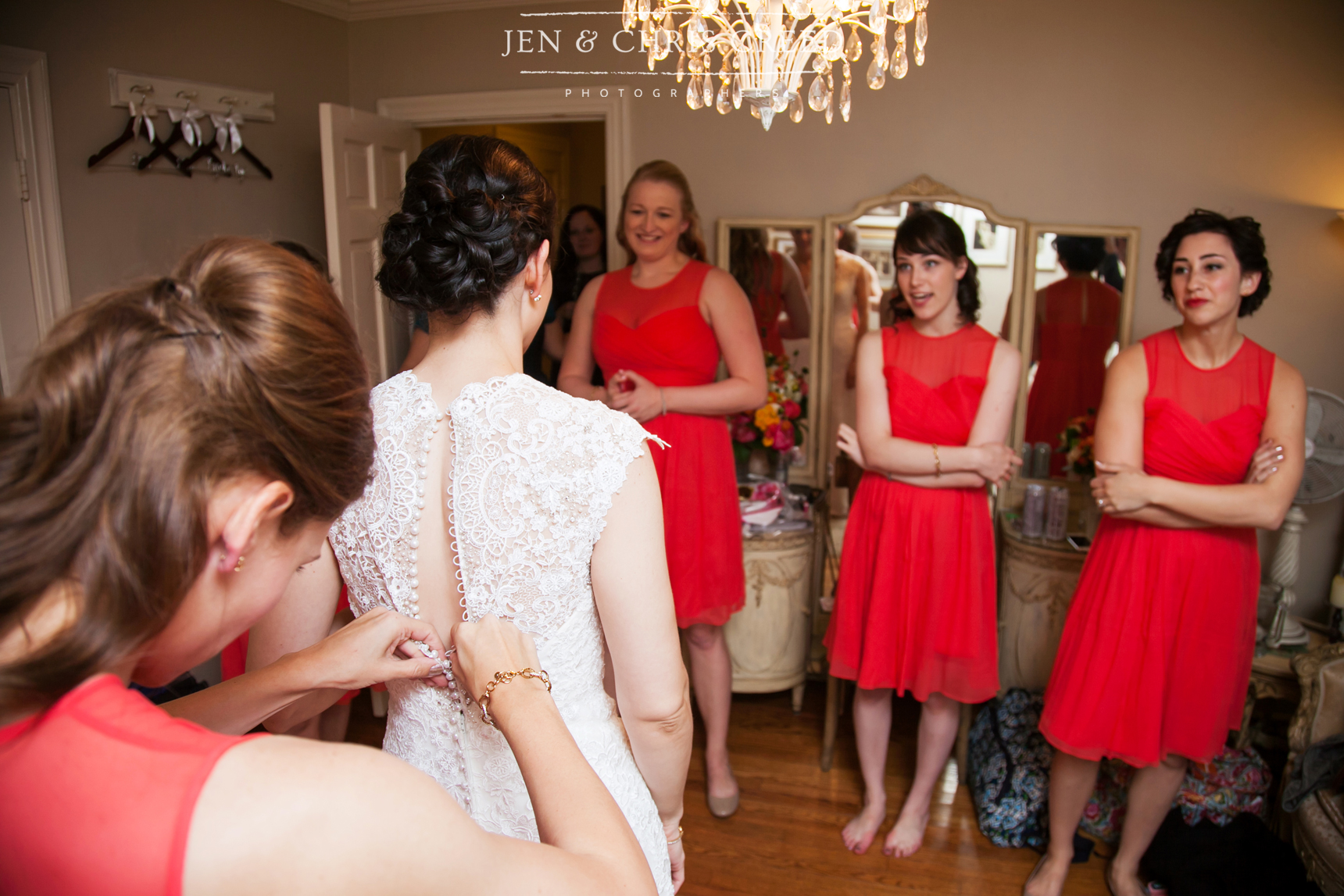 sister buttoning bride's dress