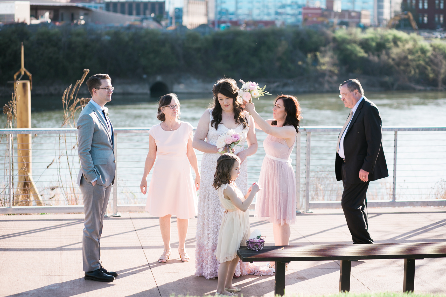 bridesmaid adjusting bride