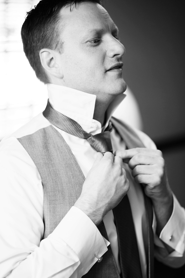 groom adjusting tie