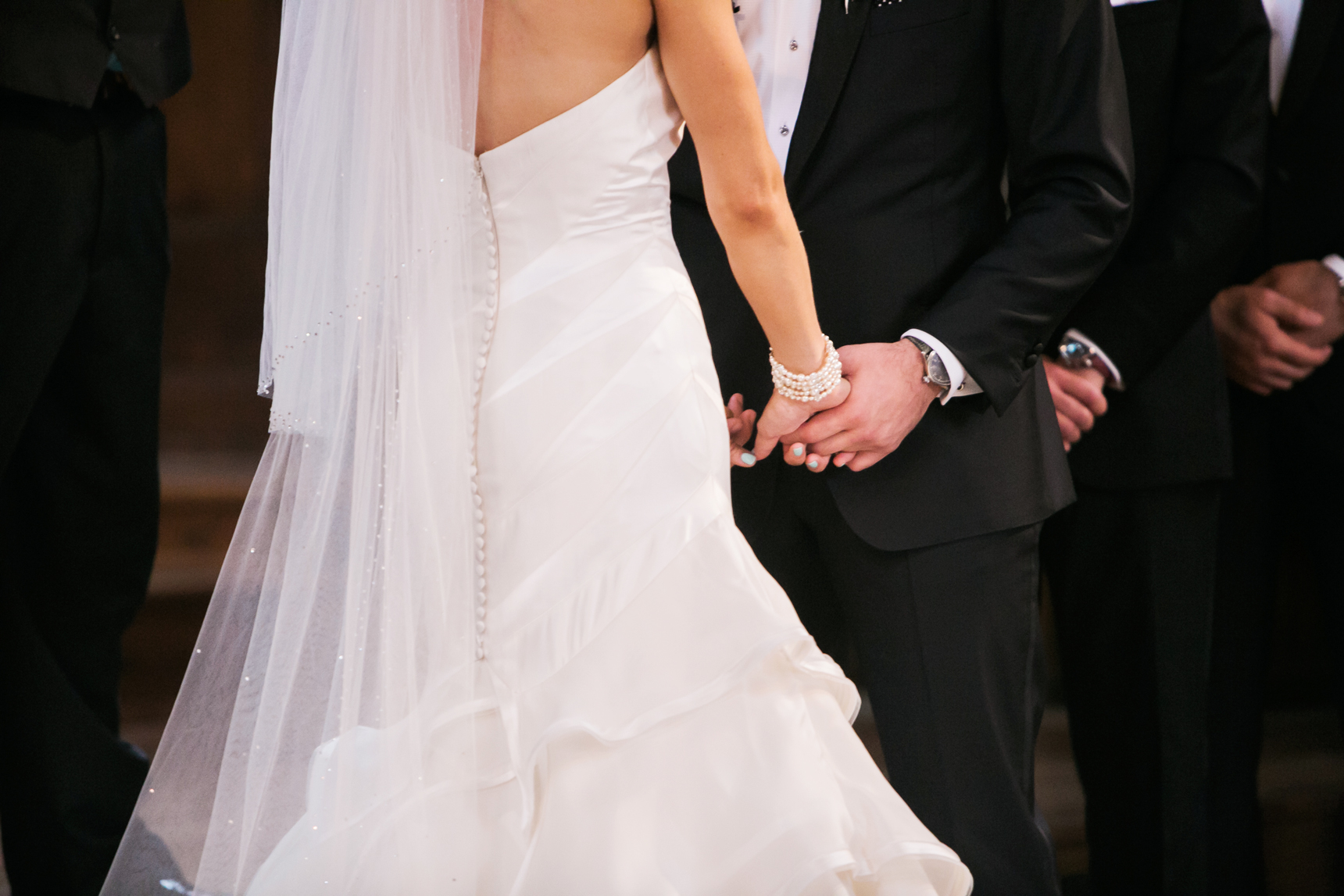 bride and groom holding hands