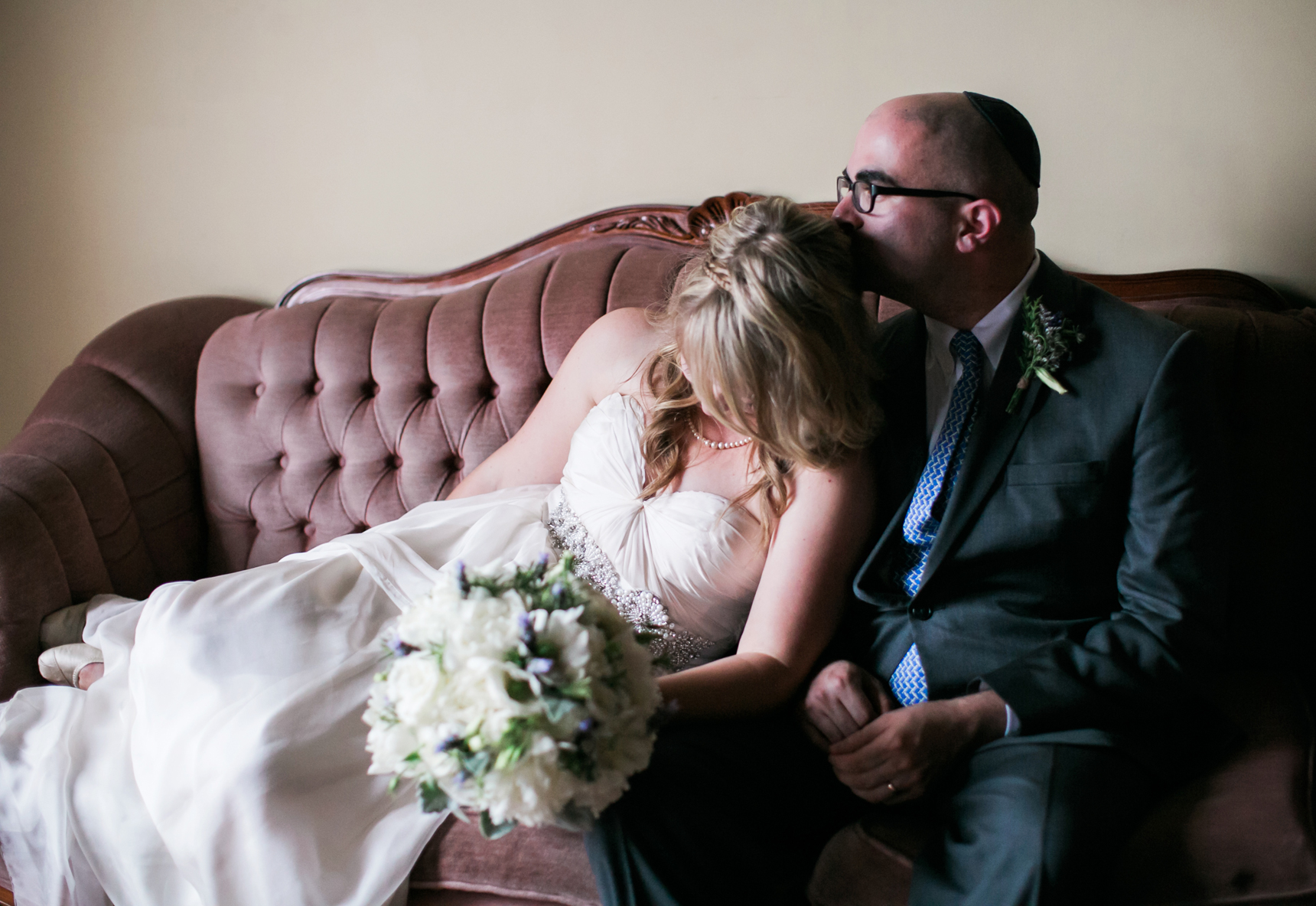 Bride and groom on couch