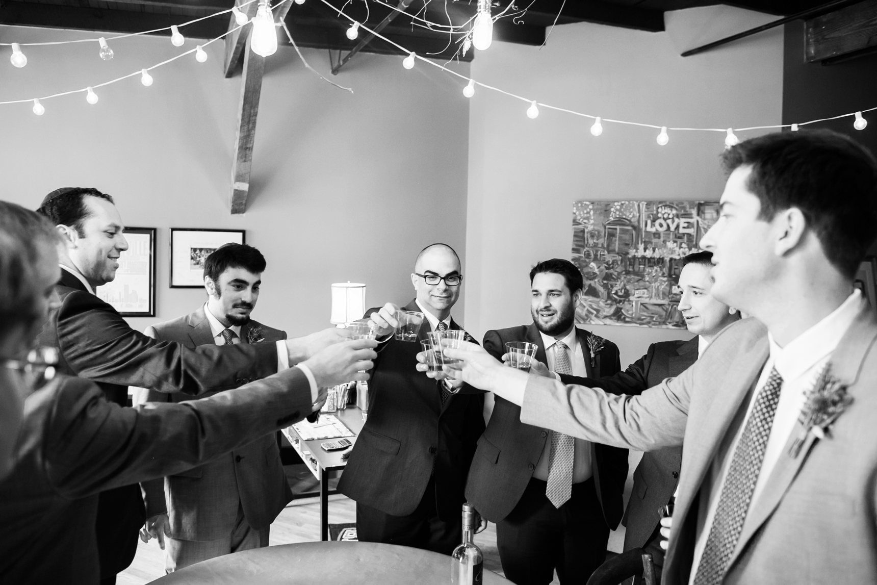 groom and groomsmen toasting