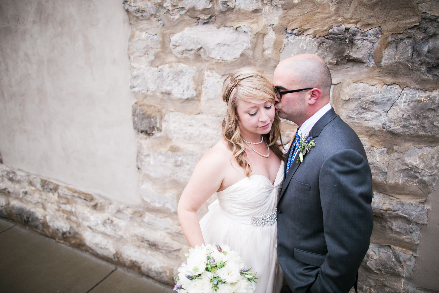 Groom kissing bride on the cheek