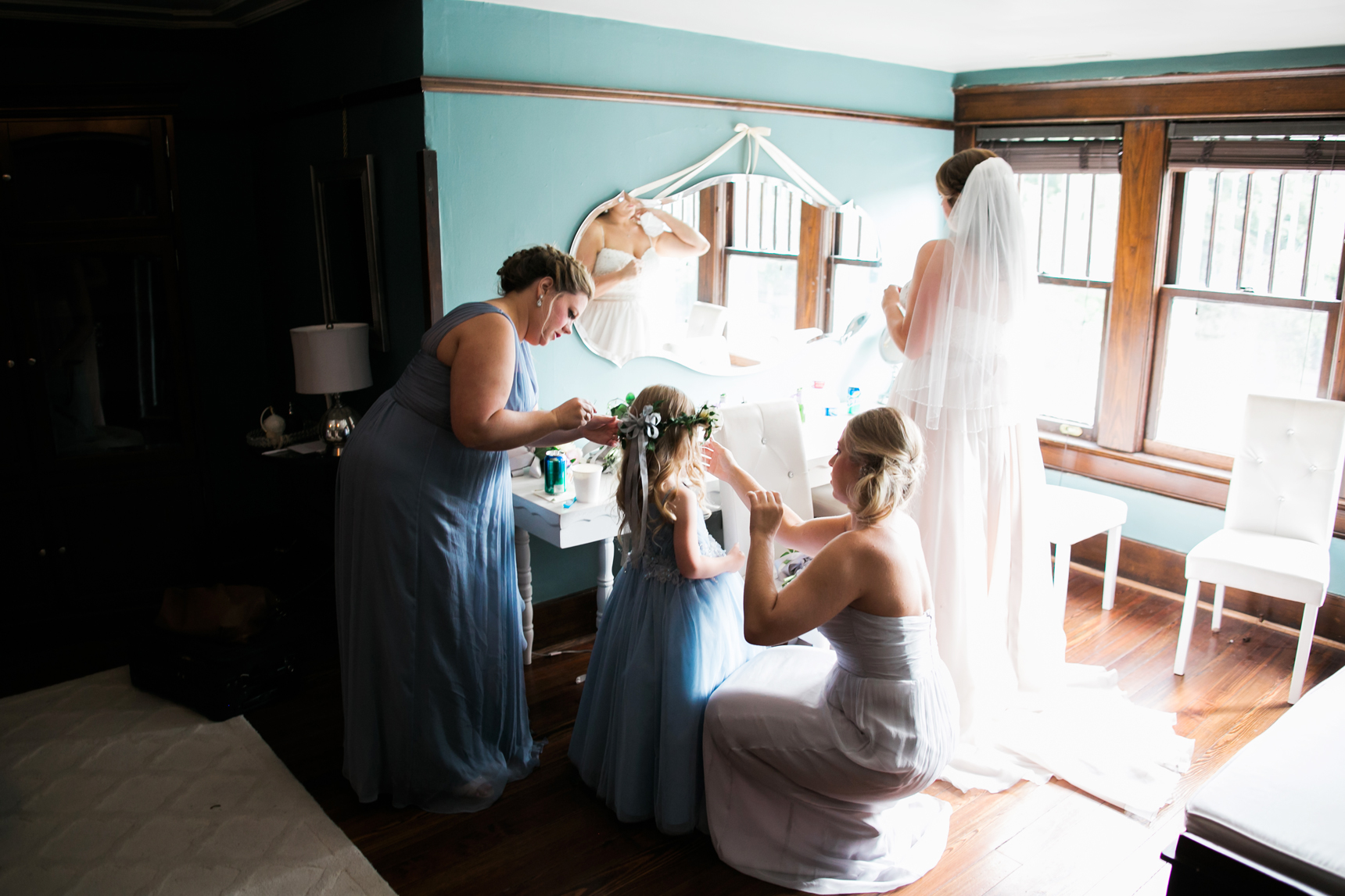 bridesmaids adjusting flower girl