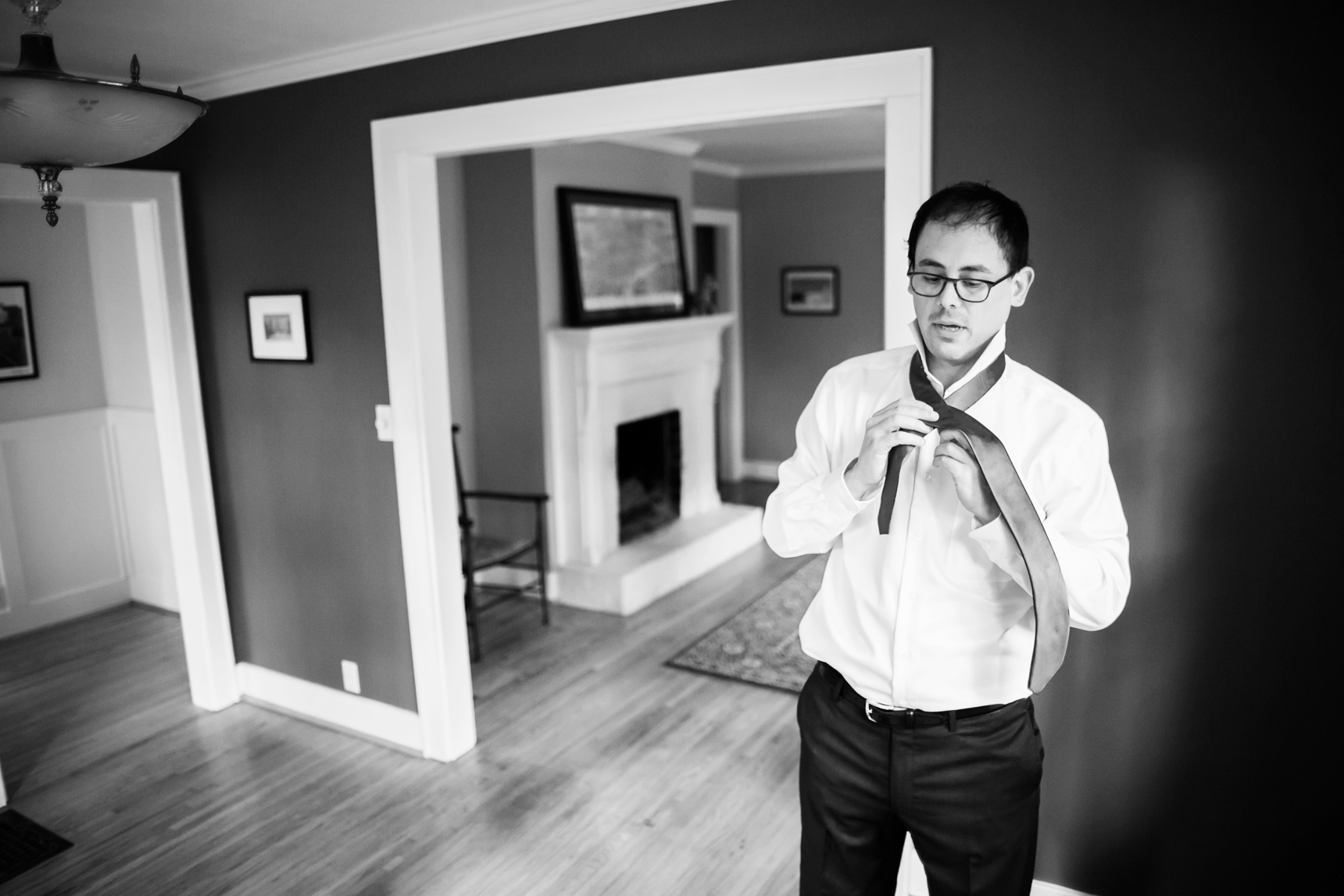 Groom tying tie