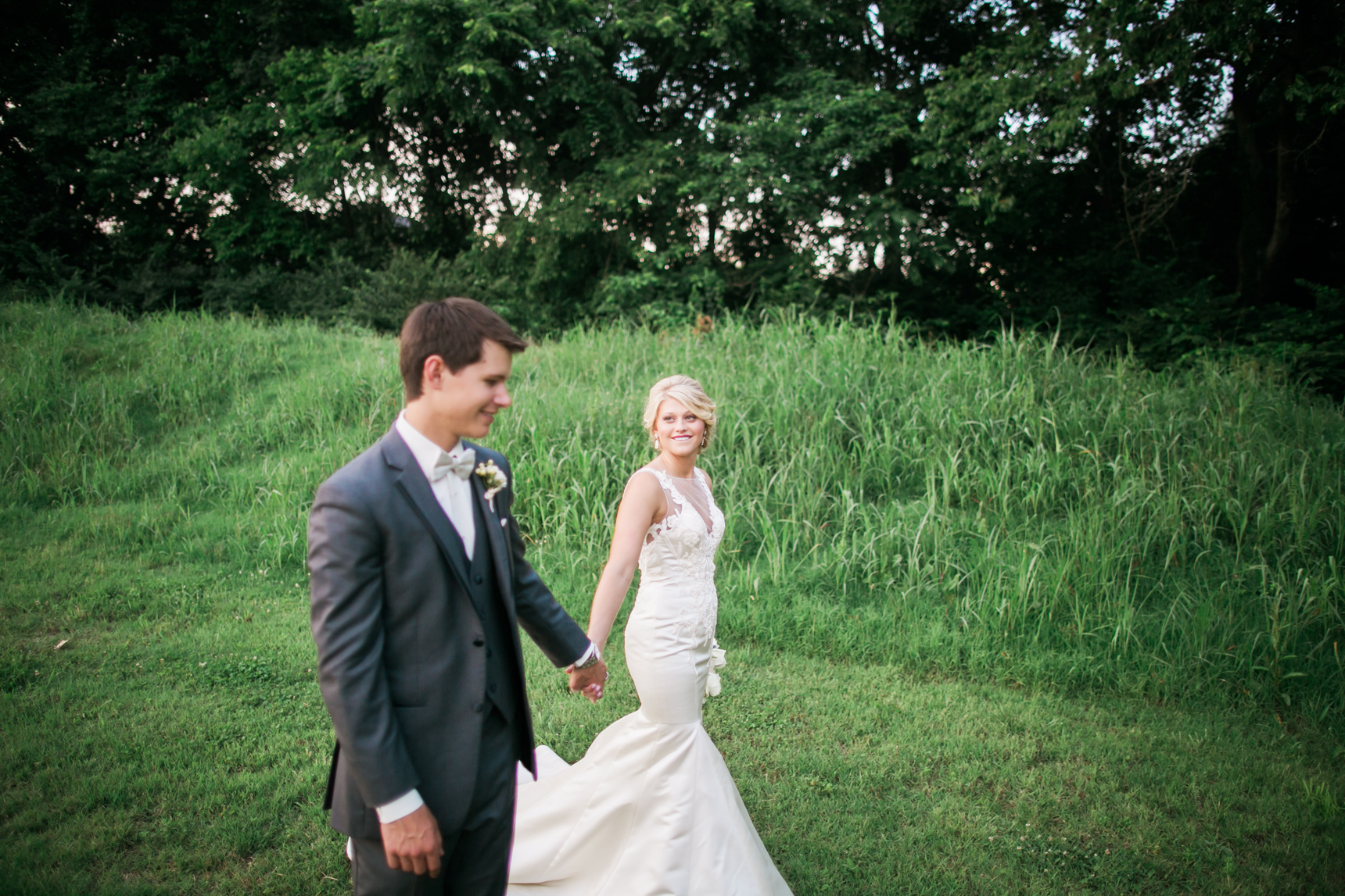 Bride and groom holding hands