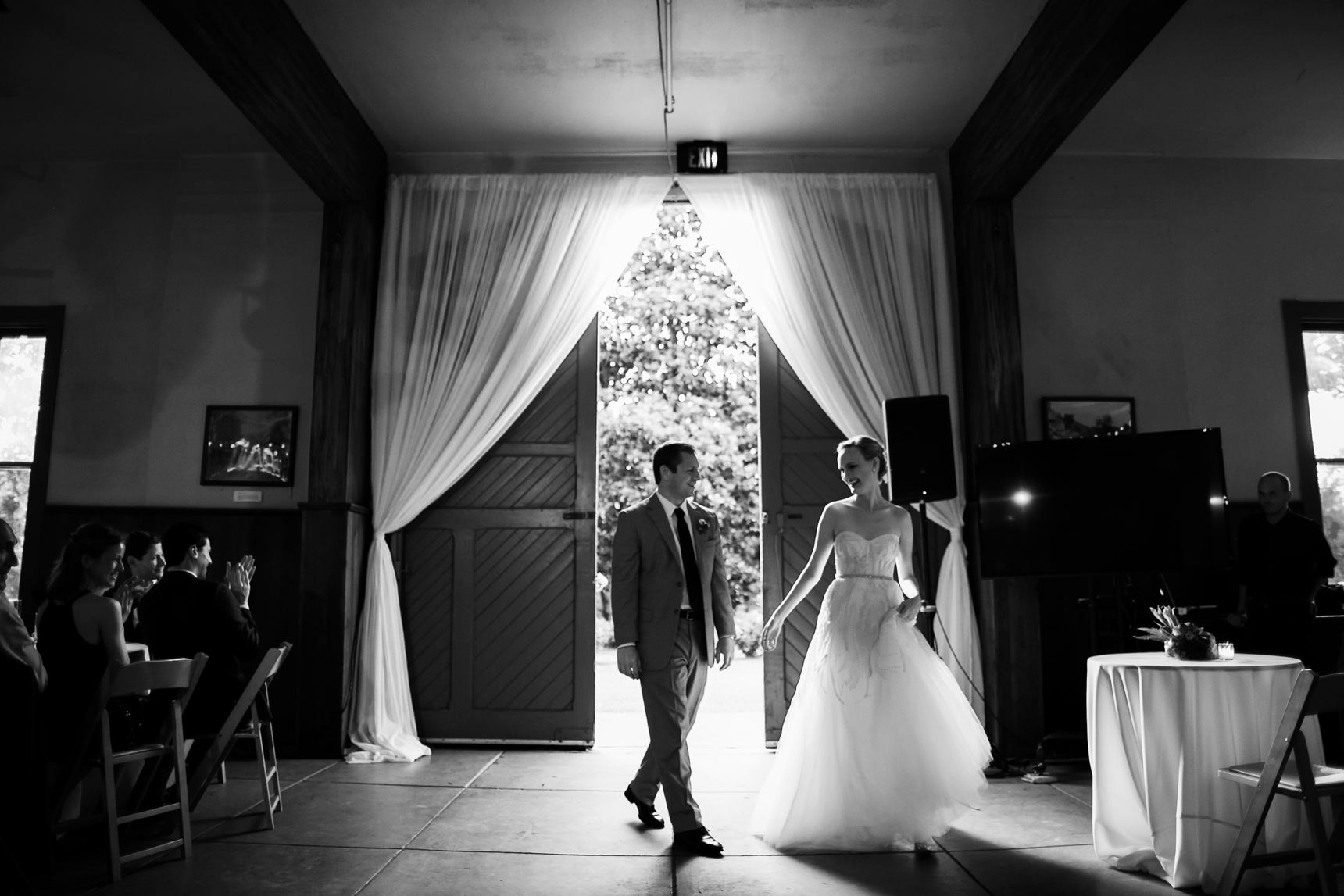 Bride and groom entering reception