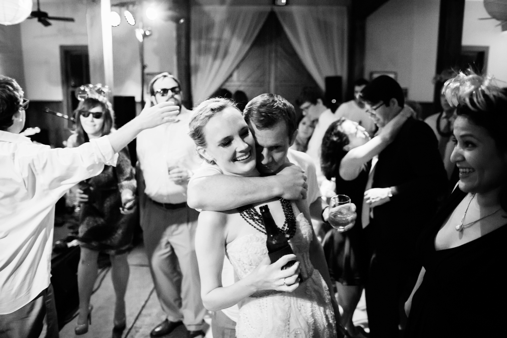 Groom hugging bride at reception