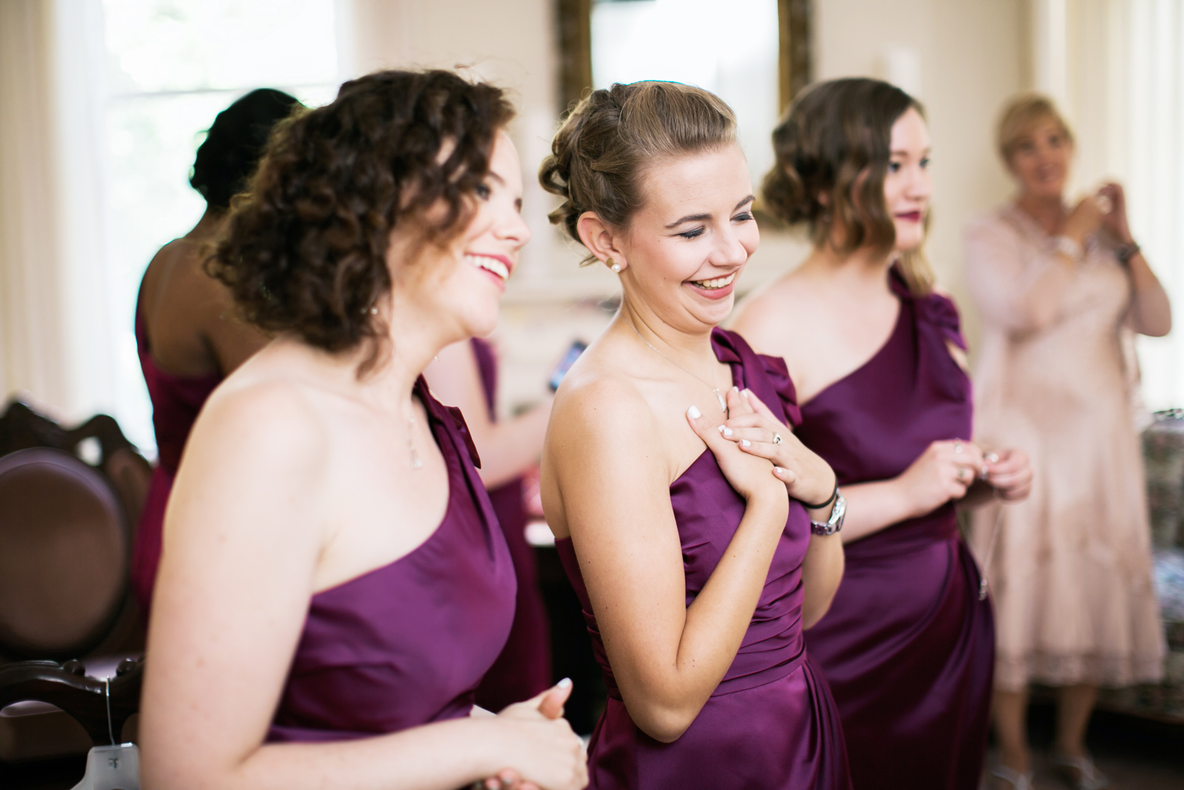 Bridesmaids seeing bride in dress