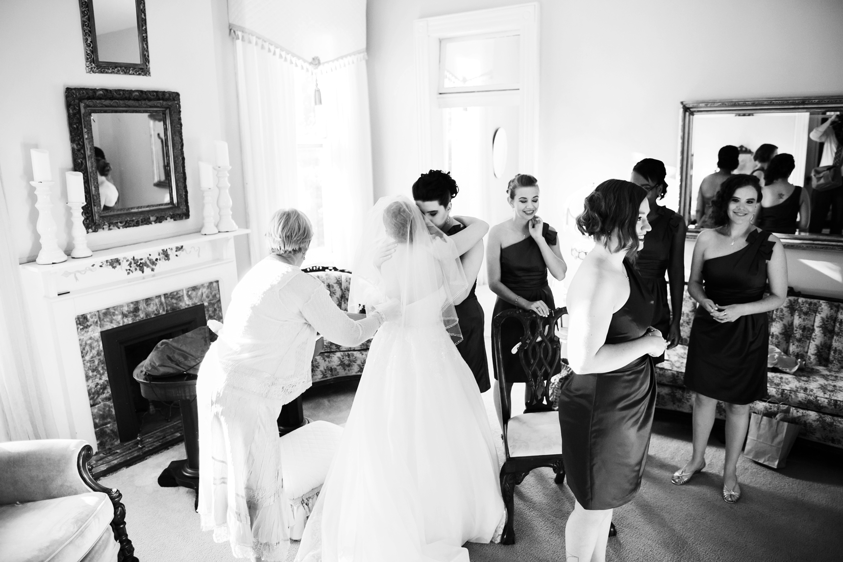 Mom adjusting bride's dress