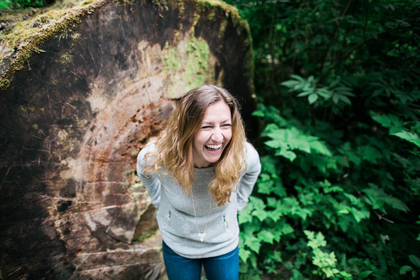 Woman laughing in forest