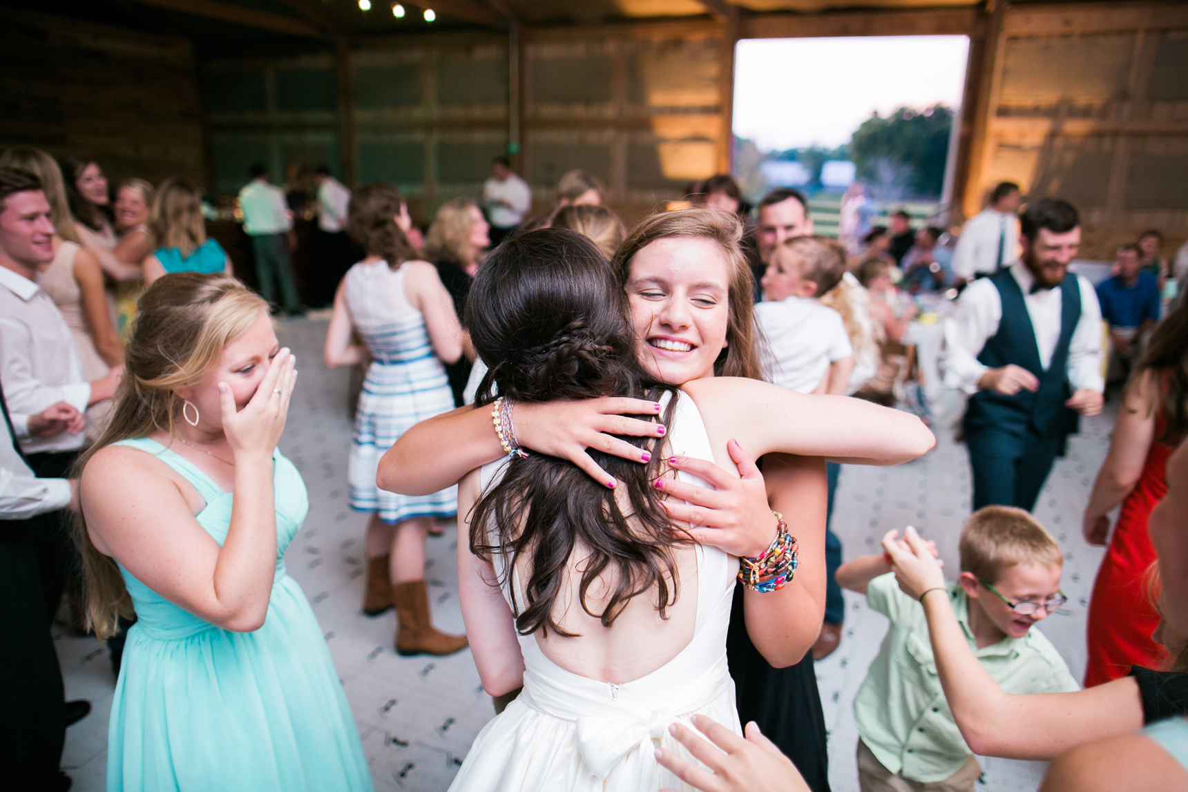 Bride hugging friends