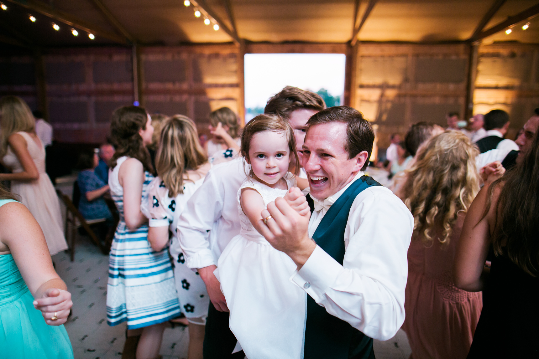 Groom dancing with flower girls