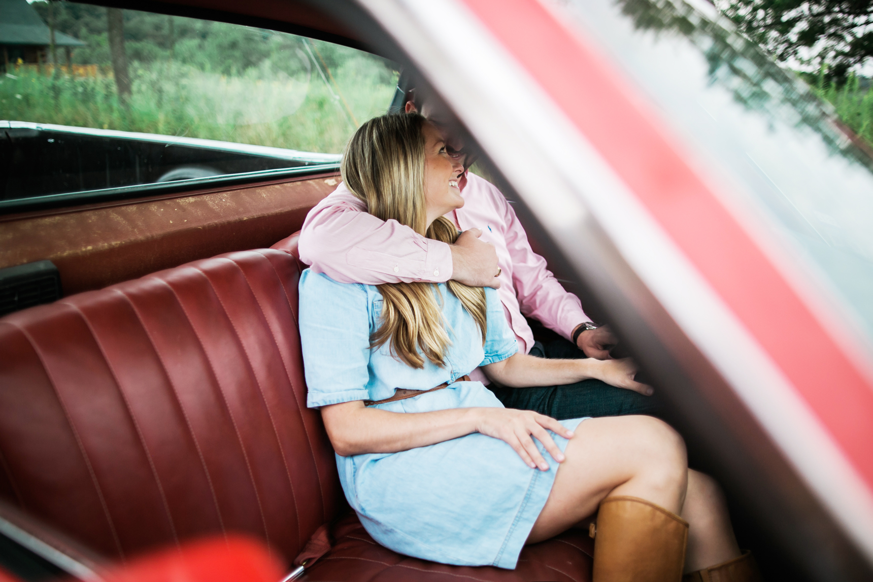 Couple sitting in old car