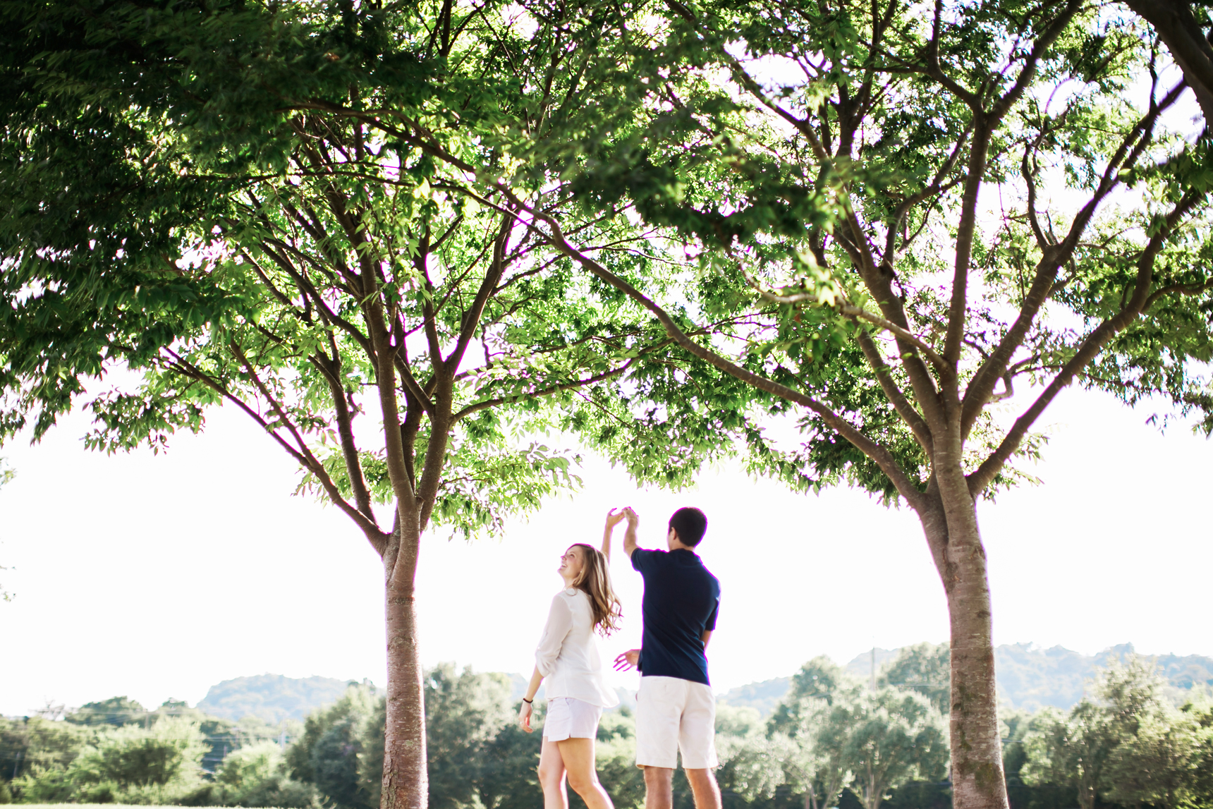 Couple dancing under trees