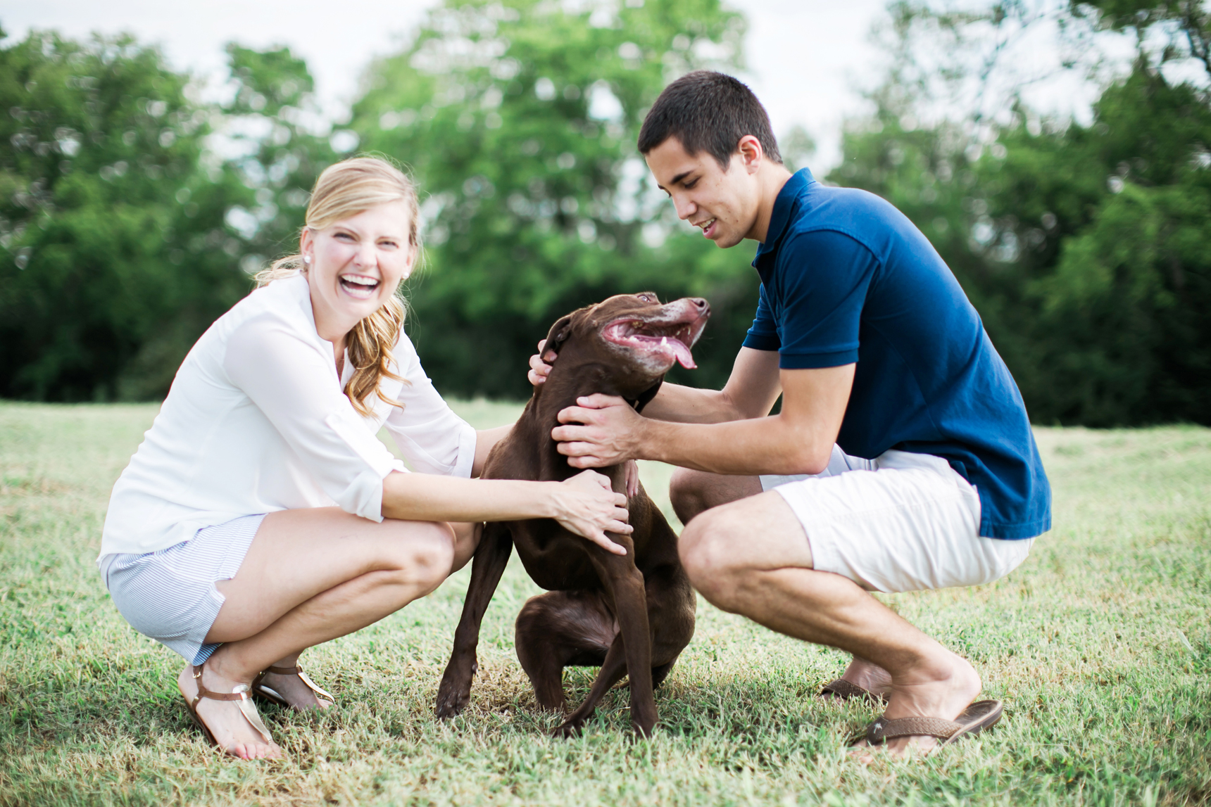 Couple playing with dog