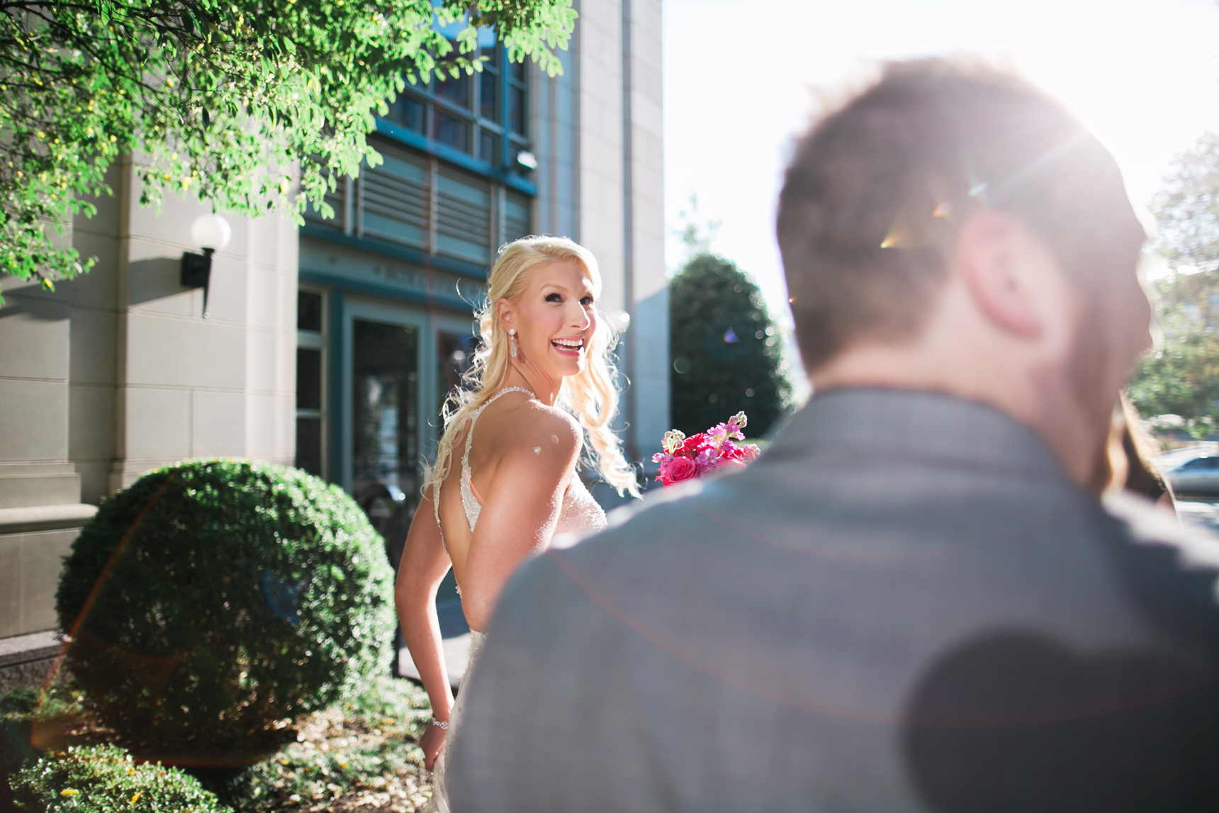 Bride looking over shoulder laughing