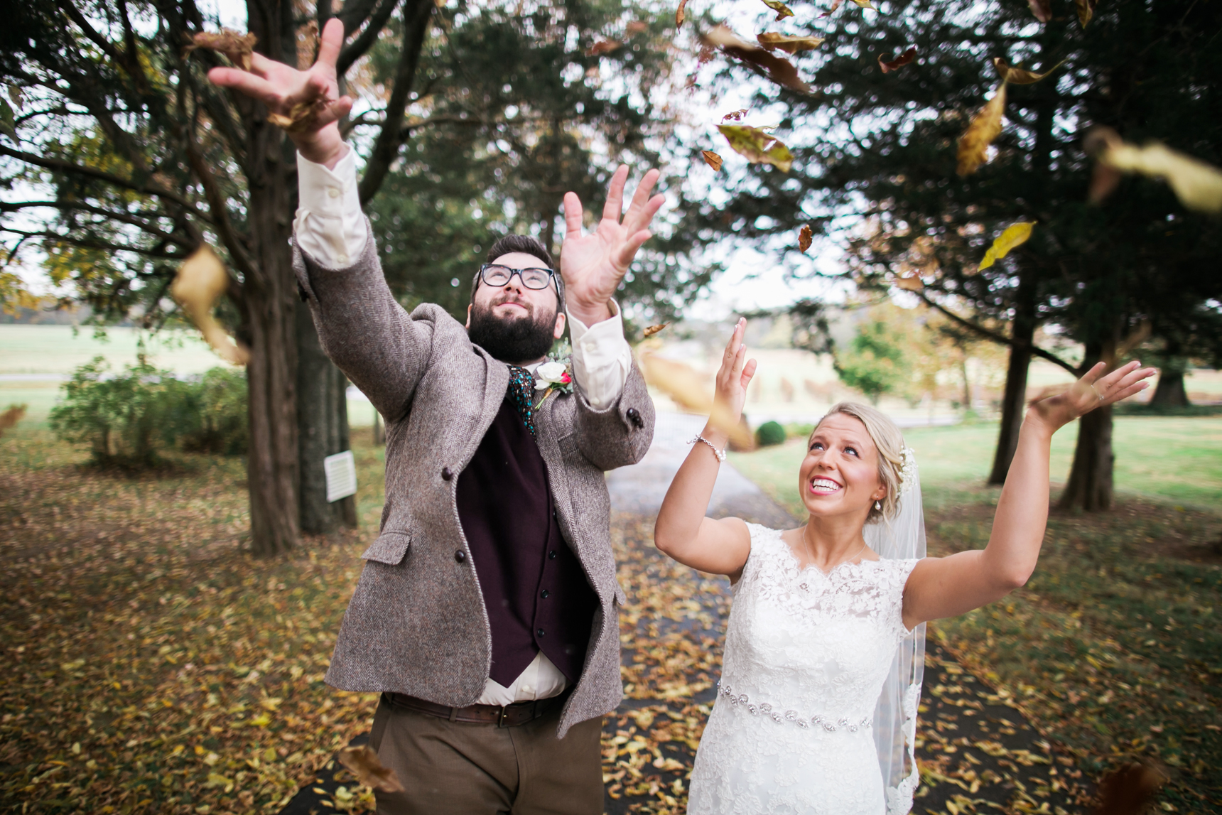 Bride and groom throwing leaves
