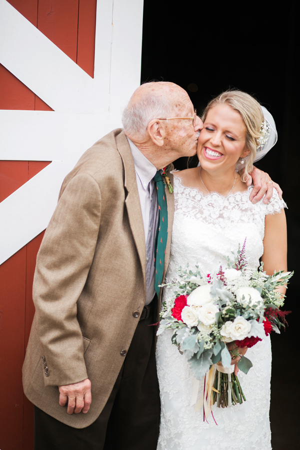 Grandfather kissing bride's cheek