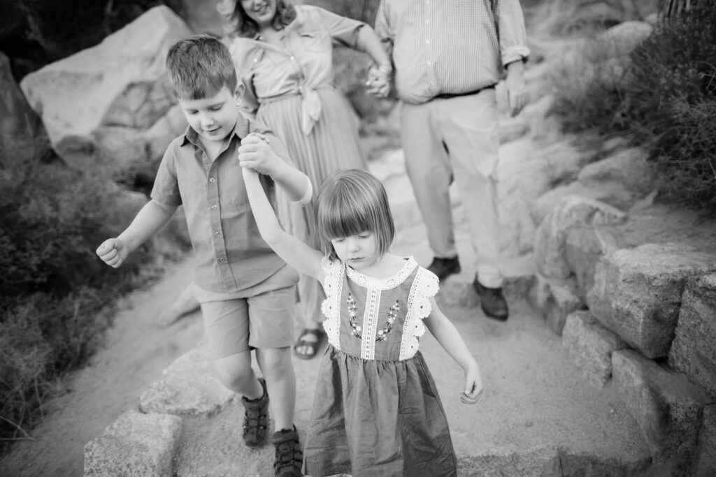 Kids holding hands on trail