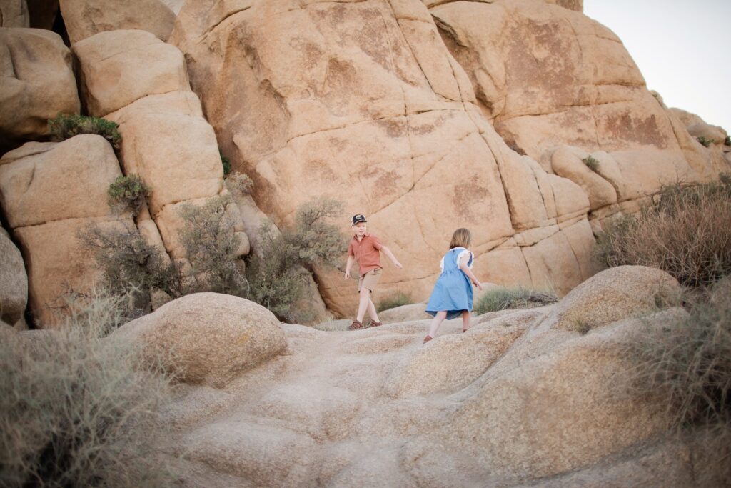 Kids walking on rock in Joshua Tree